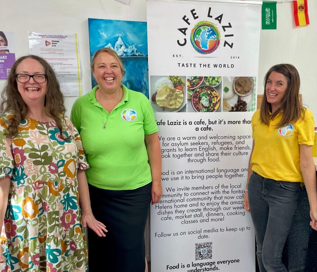 Deputy treasurer Emma and Cafe Laziz staff Claire and Emma smiling together.