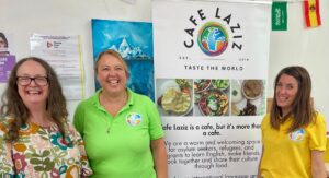 Deputy treasurer Emma and Cafe Laziz staff Claire and Emma smiling together.